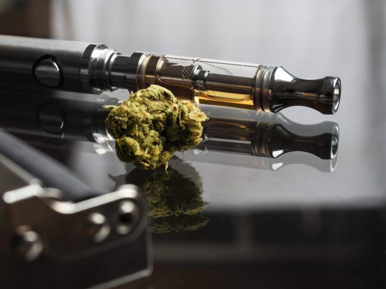 Close-up-cannabis-with-cannabis-oil-in-cartridge-of-vape-pen-Credit-KampolG-Creative-1360292593-scaled-e1680186417182